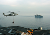 An Mh-60s Knighthawk Assigned To The  Chargers  Of Helicopter Combat Support Squadron Six (hc-6), Detachment 4, Delivers Supplies To Uss George Washington (cvn 73). Image