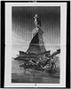[statue Of Liberty Floating In Bay And Statue Of Cow, Wearing Crown And Collar With $ Sign, Standing On Liberty S Pedestal]  / Keppler. Image