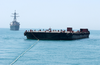 A Tug Pulling Oil Barges Suspected Of Smuggling Illegal Oil Out Of Iraq Is Followed By Uss Hopper. Image