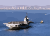 A Tugboat Tows The Decommissioned Aircraft Carrier Midway Into San Diego Bay. Clip Art