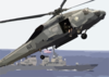 An Sh-60 Seahawk Helicopter Slows Down To Lower It Clip Art