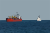The U.s. Coast Guard High Endurance Cutter Boutwell (whec 719) Moves Into Position Along-side A Cargo Ship To Deploy A Visit, Board, Search And Seizure (vbss) Team. Clip Art