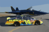 The Navy Sponsored Chevrolet Monte Carlo Busch Series Race, Show Car Is Parked On The Tarmac Near F/a-18 Hornets Assigned To The Navy S Flight Demonstration Team, The Blue Angels, At Sherman Field Onboard Nas Pensacola. Clip Art