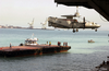 An E-2c  Hawkeye  Is Hoisted And Lowered Onto A Barge In Bahrain Image
