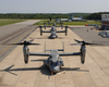 Four V-22 Osprey Aircraft Sit Along The Flight Line With Rotors Turning Before Recent Test Flights Image