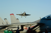 An F/a-18c Hornet Flies Over The Flight Deck Of Uss George Washington (cvn 73) Image