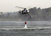 Two Uh-3h Sea King Helicopters Assigned To The Golden Gaters Of Helicopter Combat Support Squadron Eighty Five (hc-85) Dip Their Bambi Bucket Into A Lake To Aid In The Firefighting Effort. Image
