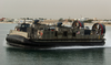 Lcac Departs From A Large Cement Parking Pad On A Beach Image